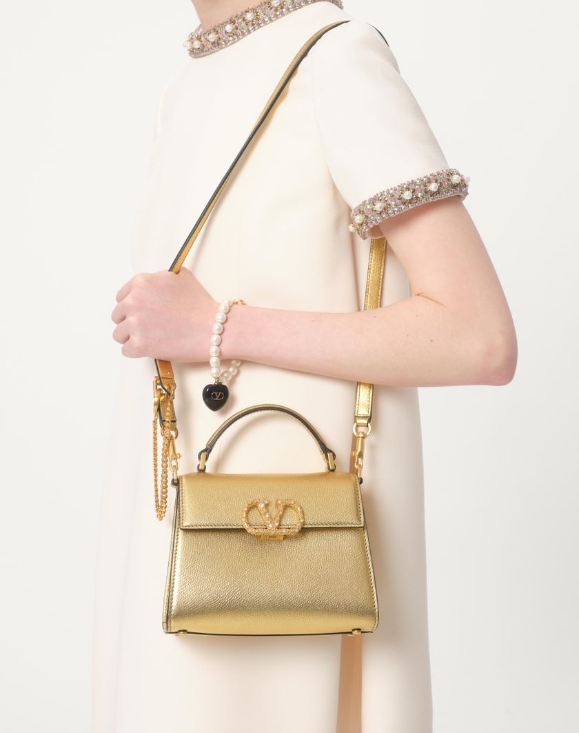 Valentino Handbags Borsa A Mano Mini Valentino Garavani Vsling In Vitello Granato Laminato Con Logo Gioiello per Donna in Violet | Valentino IT I Più Venduti
